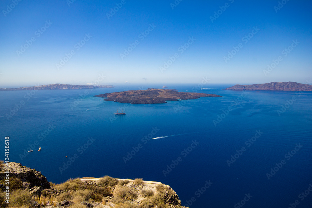 Panorama of Nea Kameni, a small uninhabited Greek island of volcanic origin located in the Aegean Sea and Santorini caldera.