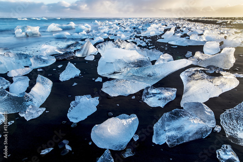 Ice diamonds glistening on the black beach 