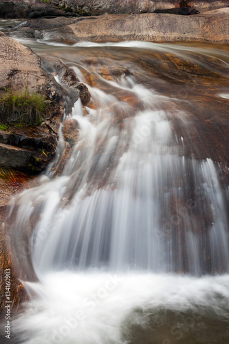 Waterfall close-up with brown rocks