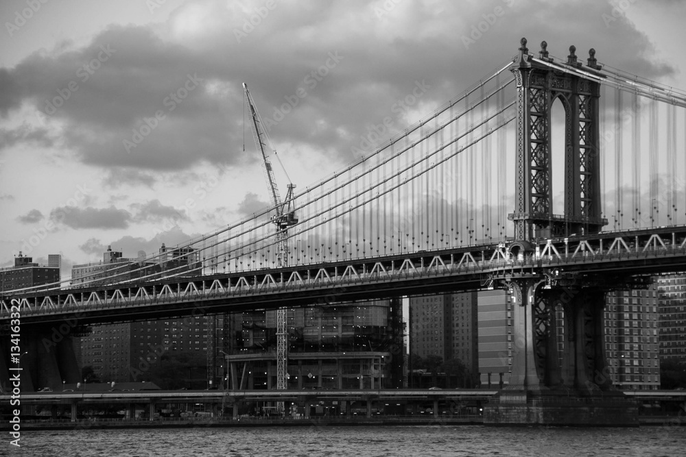 Manhattan bridge over the river and the city in black and white style, New York