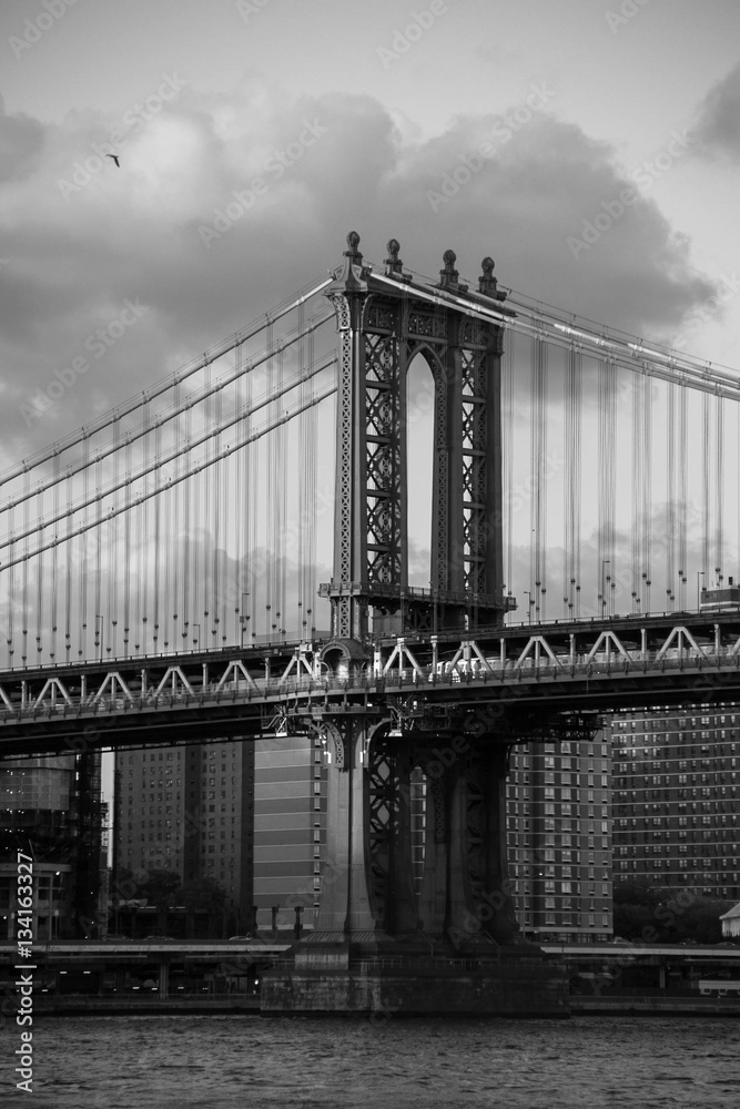 Manhattan bridge with cloudy sky in black and white style, New York