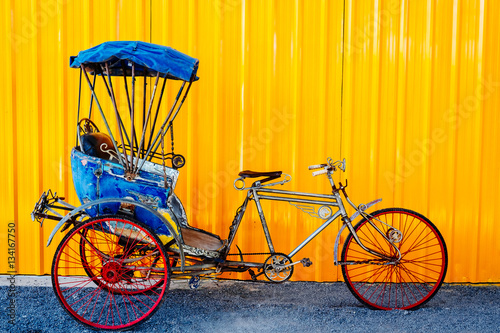 Photography Old thai Cycle rickshaw/ Trishaws against yellow wall on background
