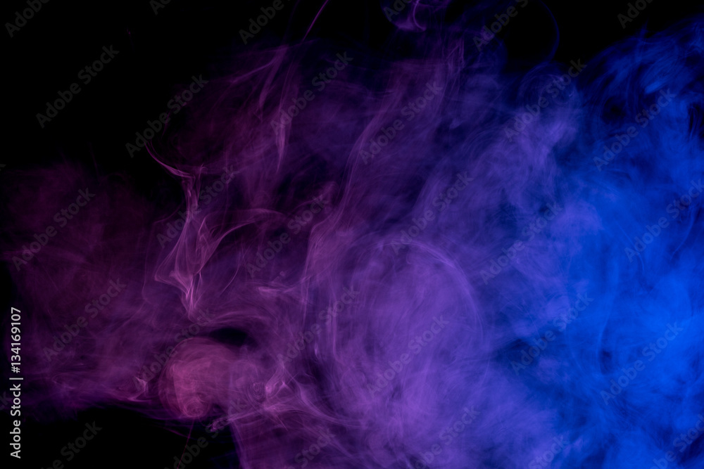 Abstract smoke Weipa. Personal vaporizers fragrant steam. The concept of alternative non-nicotine smoking. Blue lilac smoke on a black background. E-cigarette. Evaporator. Taking Close-up. Vaping. Abstract smoke Weipa. Personal vaporizers fragrant steam. The concept of alternative non-nicotine smoking. Blue lilac smoke on a black background. E-cigarette. Evaporator. Taking Close-up. Vaping.