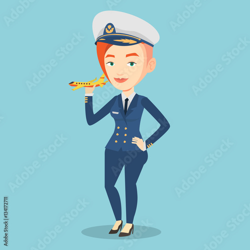 Cheerful airline pilot with model airplane.