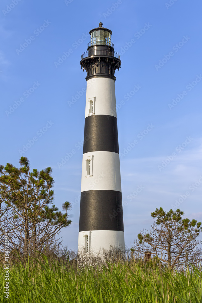 The historic Bodie Island Lighthouse rises over the coastal landscape of Cape Hatteras National Seashore on the Outer Banks of North Carolina.