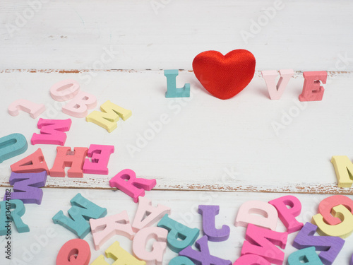 Vanlentine's day concept. Wooden letters word love and red heart and car vintage on color background with copy space.
