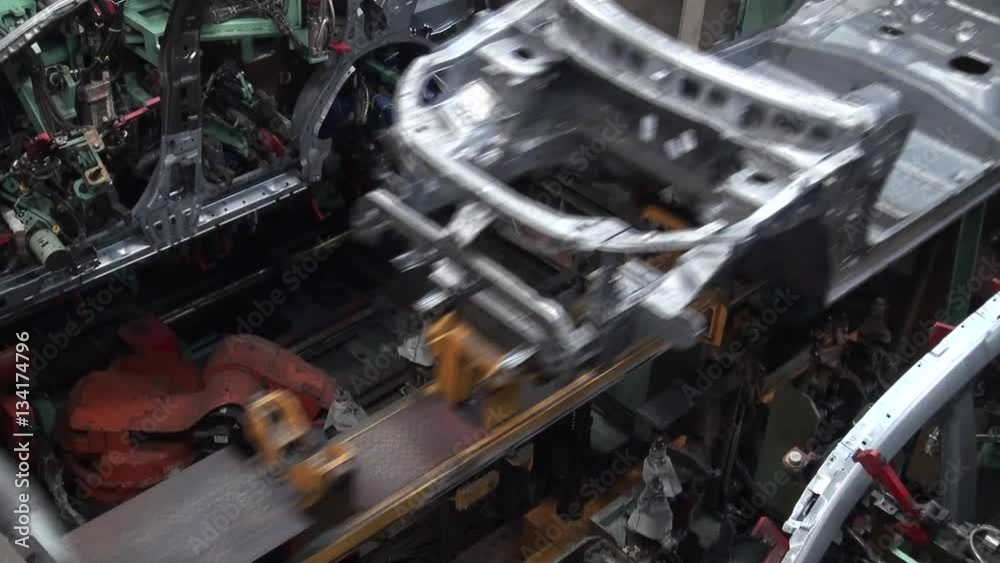 Car factory. Robotic arm machine welding and joining pieces. Making car in working lines Car factory. Robotic arm machine welding and joining pieces. Making car in working lines