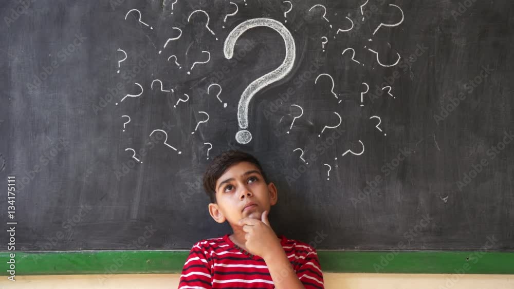Concepts on blackboard at school. Young people, quiet student and pupil in classroom. Hispanic boy with doubts and thoughts in class. Portrait of male child thinking