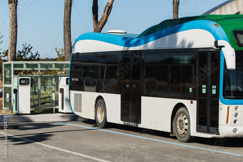 Electric vehicle bus stands at the charger. Alternative sources of fuel.