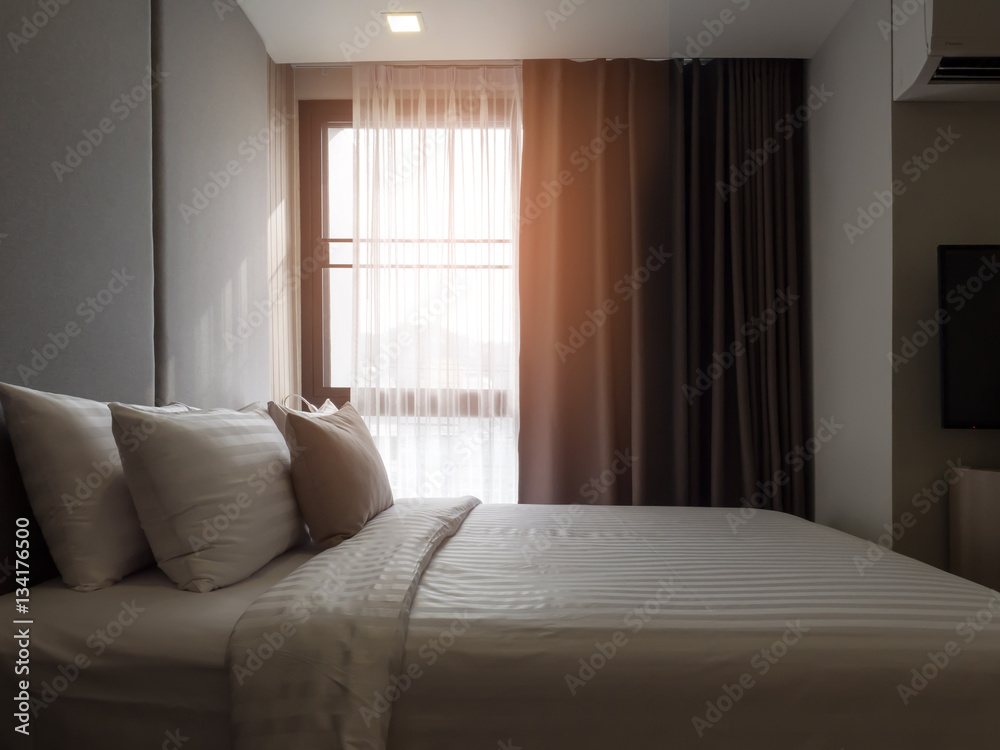 Interior of cozy bedroom in modern design.low lighting and Lens flair in sunlight. Interior of cozy bedroom in modern design.low lighting and Lens flair in sunlight.