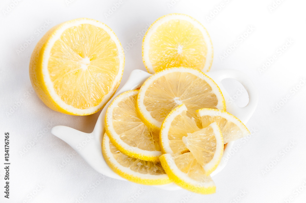 Lemon sliced lies on a plate shaped Lemon sliced lies on a plate shaped