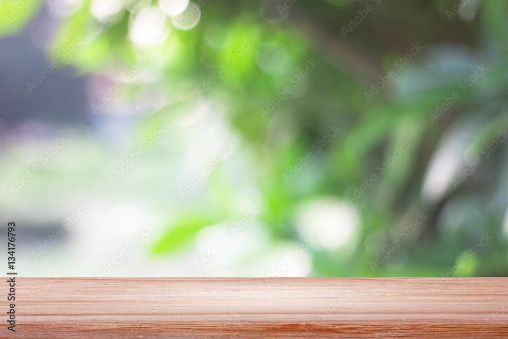 empty wooden on blurred nature backdrop. Wood table top. can used for display or montage your products empty wooden on blurred nature backdrop. Wood table top. can used for display or montage your products