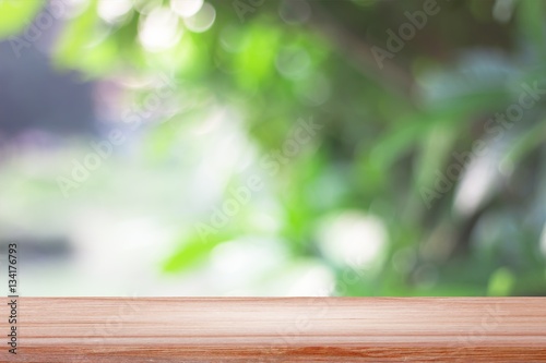 empty wooden on blurred nature backdrop. Wood table top. can used for display or montage your products