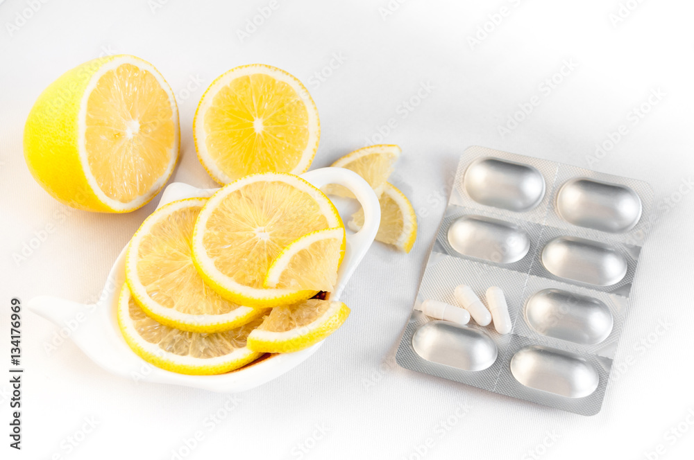 Lemon and chopped tablets lie on a white background