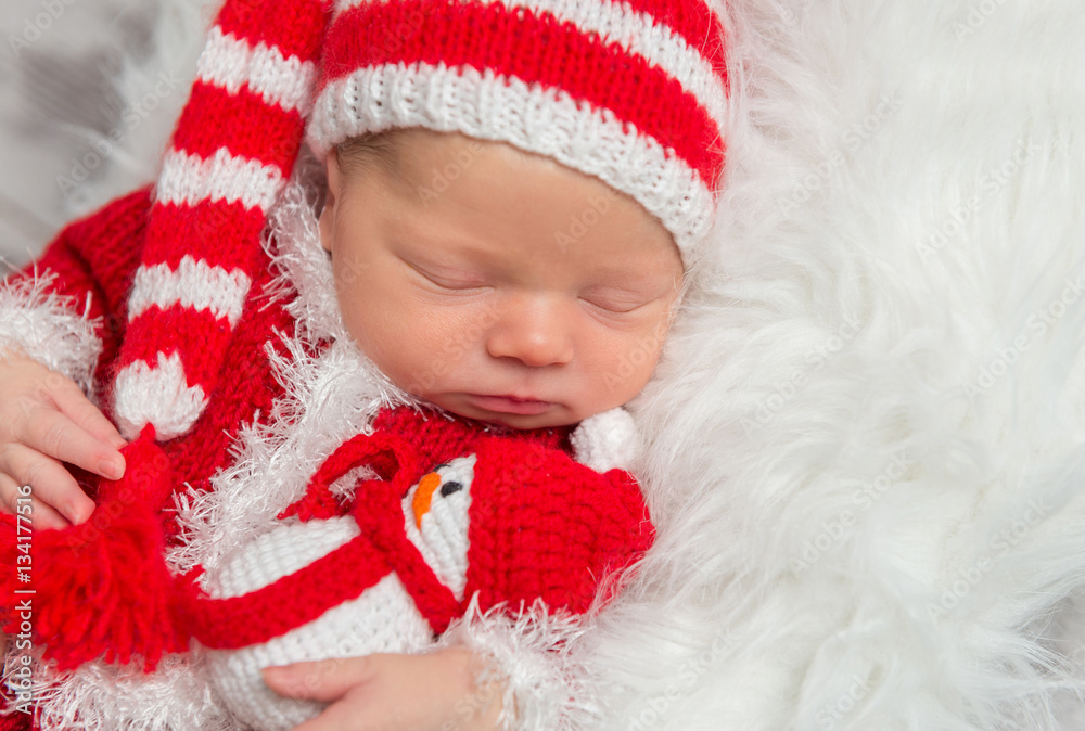 Newborn sleeping with a toy, closeup Newborn sleeping with a toy, closeup