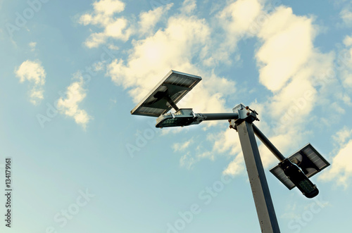 small solar panel against blue skies and cloud