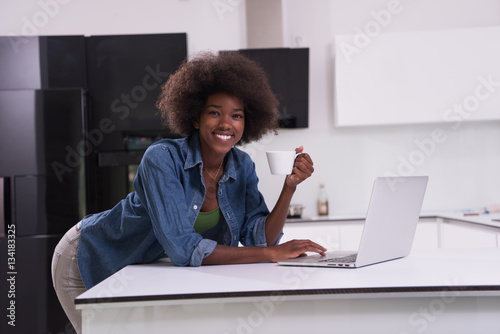 smiling black woman in modern kitchen