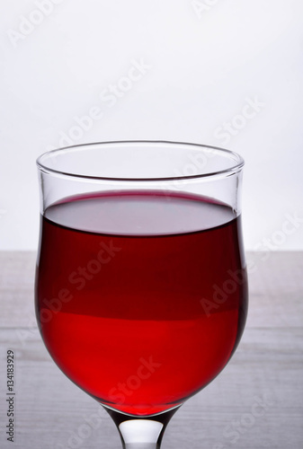 glass of red wine .glass of wine on a light wooden background