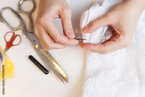 Woman unpick fabric on table