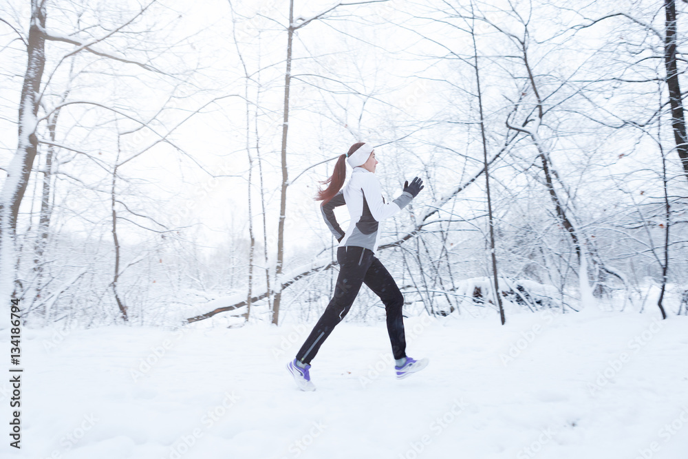 Brunette running in winter park