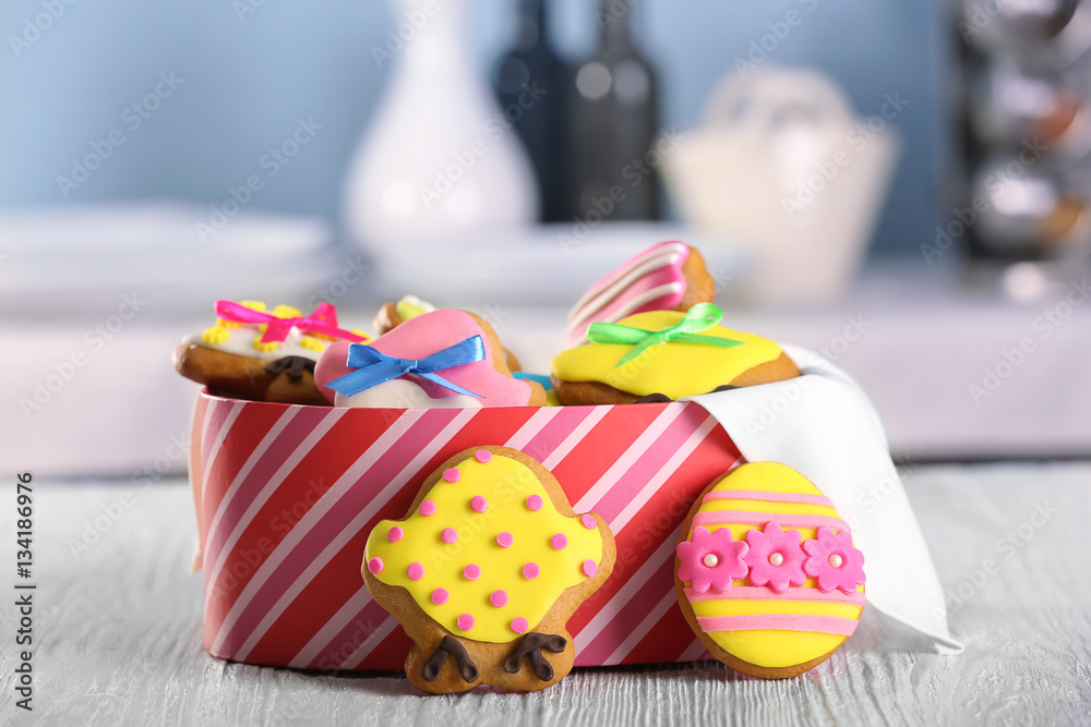 Box with tasty Easter cookies on kitchen table Box with tasty Easter cookies on kitchen table