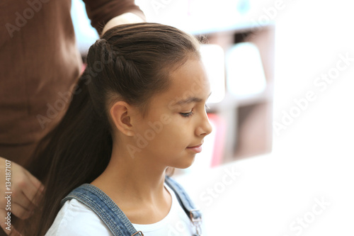 Woman doing hair of her dau...