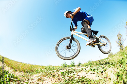 cyclist riding jumping with bicycle cross-country