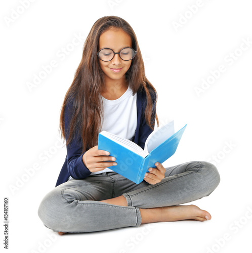 Cute girl reading book on w...