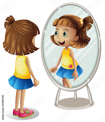 Little girl looking at herself in mirror