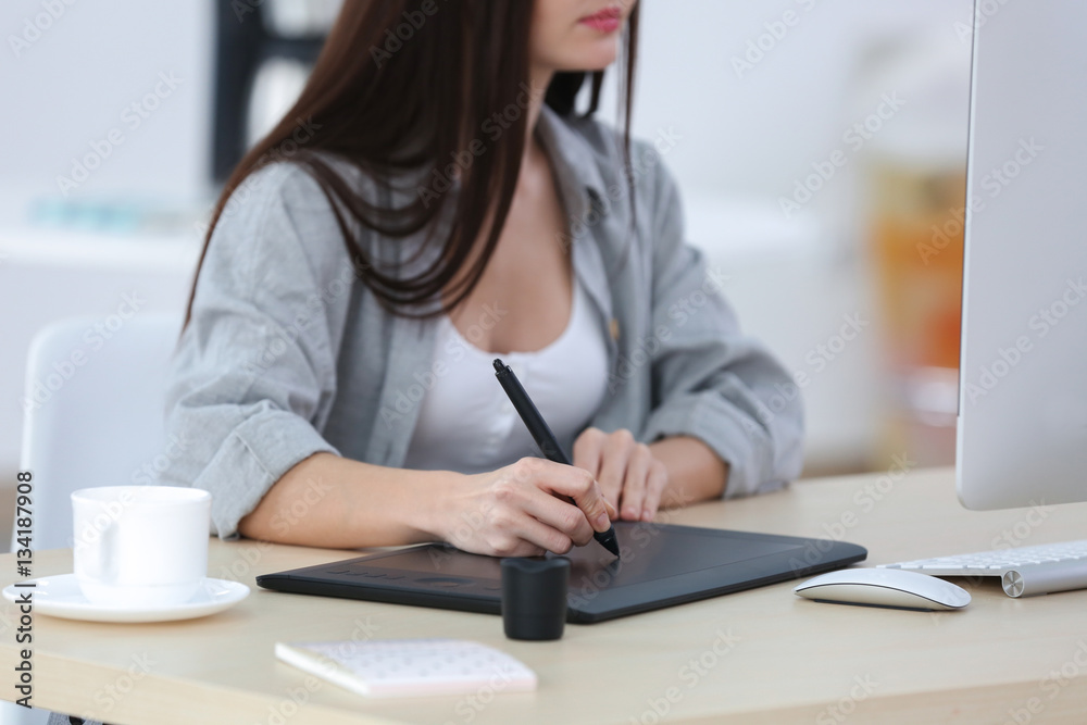 Young female designer working in office Young female designer working in office
