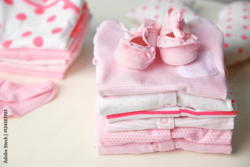 Set of baby clothes on light table Set of baby clothes on light table