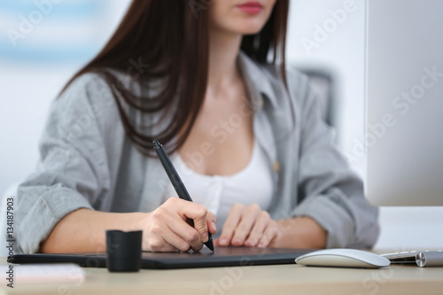 Young female designer worki...