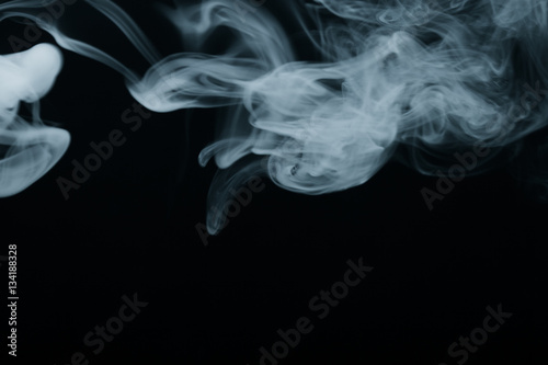 Cloud of smoke on black background. Selective focus. Toned © strannik_fox