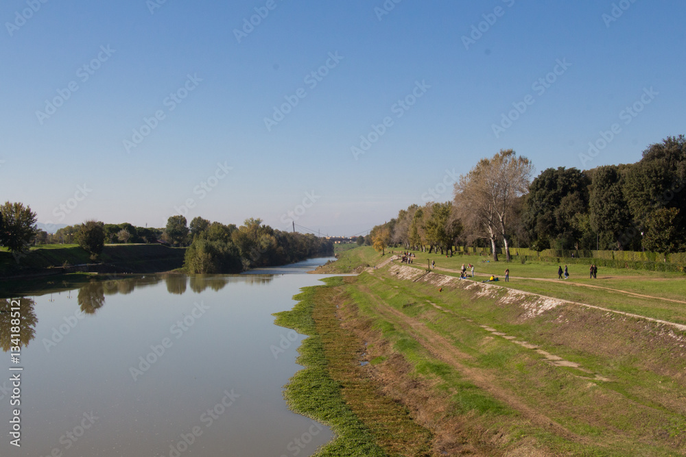 Fototapeta premium Arno river embankment in a sunny day. Florence. Italy.