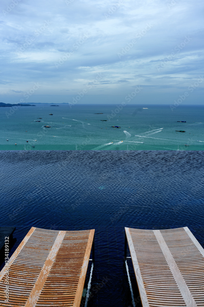 Obraz premium Wooden Sundeck on Swimming pool at Sea view