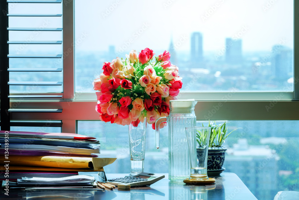 Documents and equipments on table with blur cityscape background Documents and equipments on table with blur cityscape background
