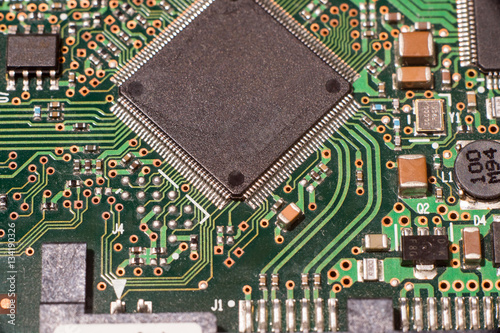Close up of electronic circuit board with microchip and components