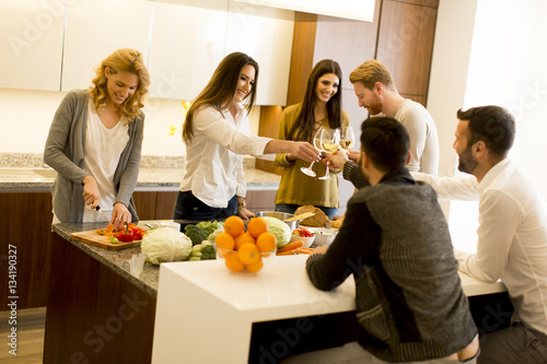 Sticker Group of young people having dinner and drinking wine in modern