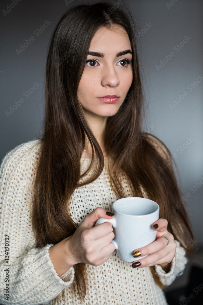 Young attractive woman drinking coffee at home Young attractive woman drinking coffee at home