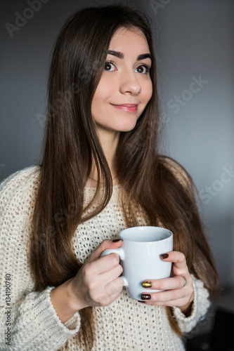 Young attractive woman drinking coffee at home