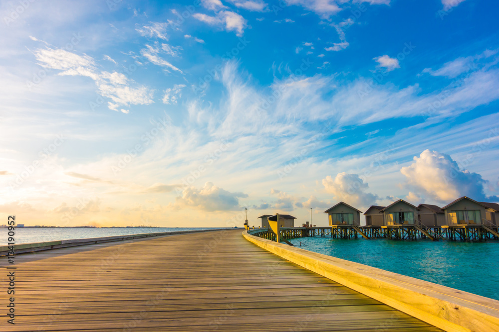 Beautiful sunrise with  water villas  in tropical Maldives islan