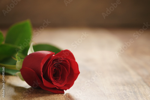 beautiful red rose on old wood table  romantic background with copy space