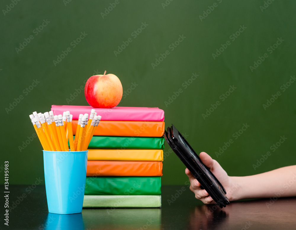 Stack of colorful books with electronic book reader near empty g Stack of colorful books with electronic book reader near empty g