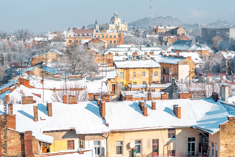 Winter view on the old town with snowbound roofs and saint George church in Lviv city, Ukraine