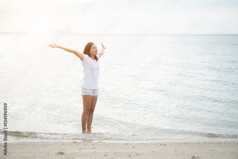 Young beautiful woman standing stretch her arms in the air on th Young beautiful woman standing stretch her arms in the air on th