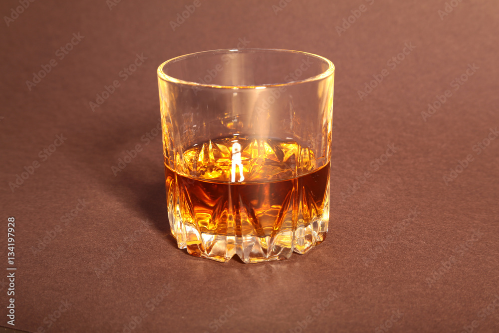 White cup of coffee and cognac in a glasses, pralines on red background. White cup of coffee and cognac in a glasses, pralines on red background.