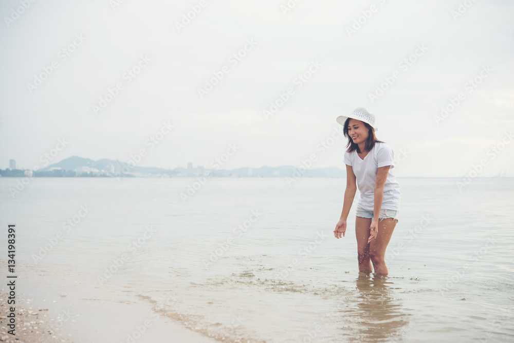 Happy young woman playing on beach at the vacation time. Happy young woman playing on beach at the vacation time.