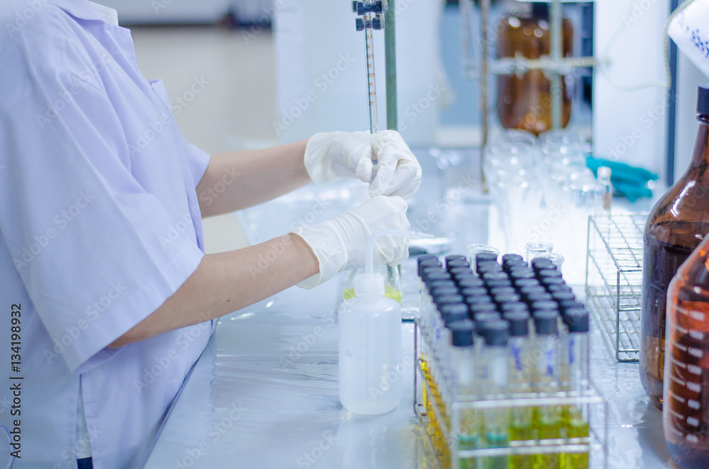 Scientist hand titration at laboratory, titrate chemical, titration