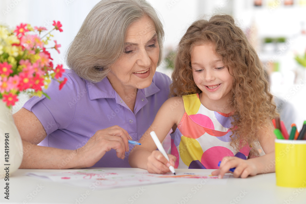 grandmother helping her granddaughter doing homework grandmother helping her granddaughter doing homework