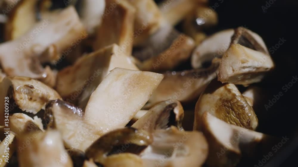 Slices of delicious fresh mushrooms fried in a pan. delicious cooking. Panning shot Slices of delicious fresh mushrooms fried in a pan. delicious cooking. Panning shot